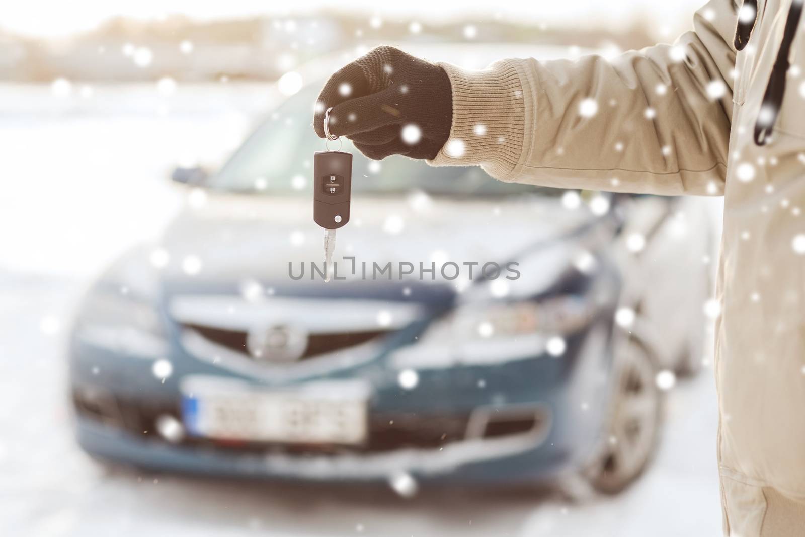 close up of man with car key outdoors by dolgachov