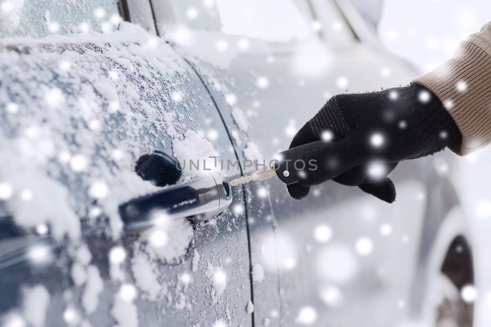 transportation, people, season and ownership concept - close up of man with car key outdoors