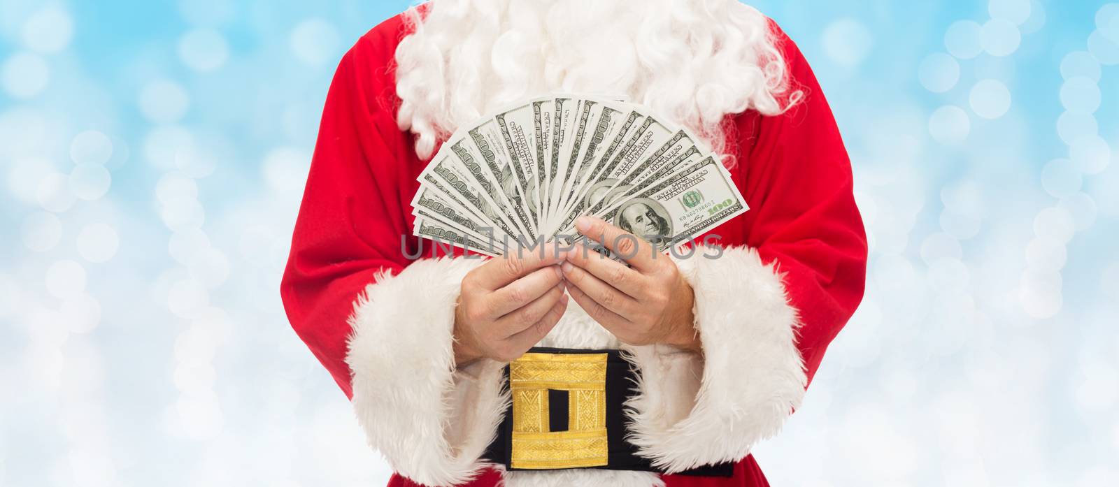 close up of santa claus with dollar money by dolgachov