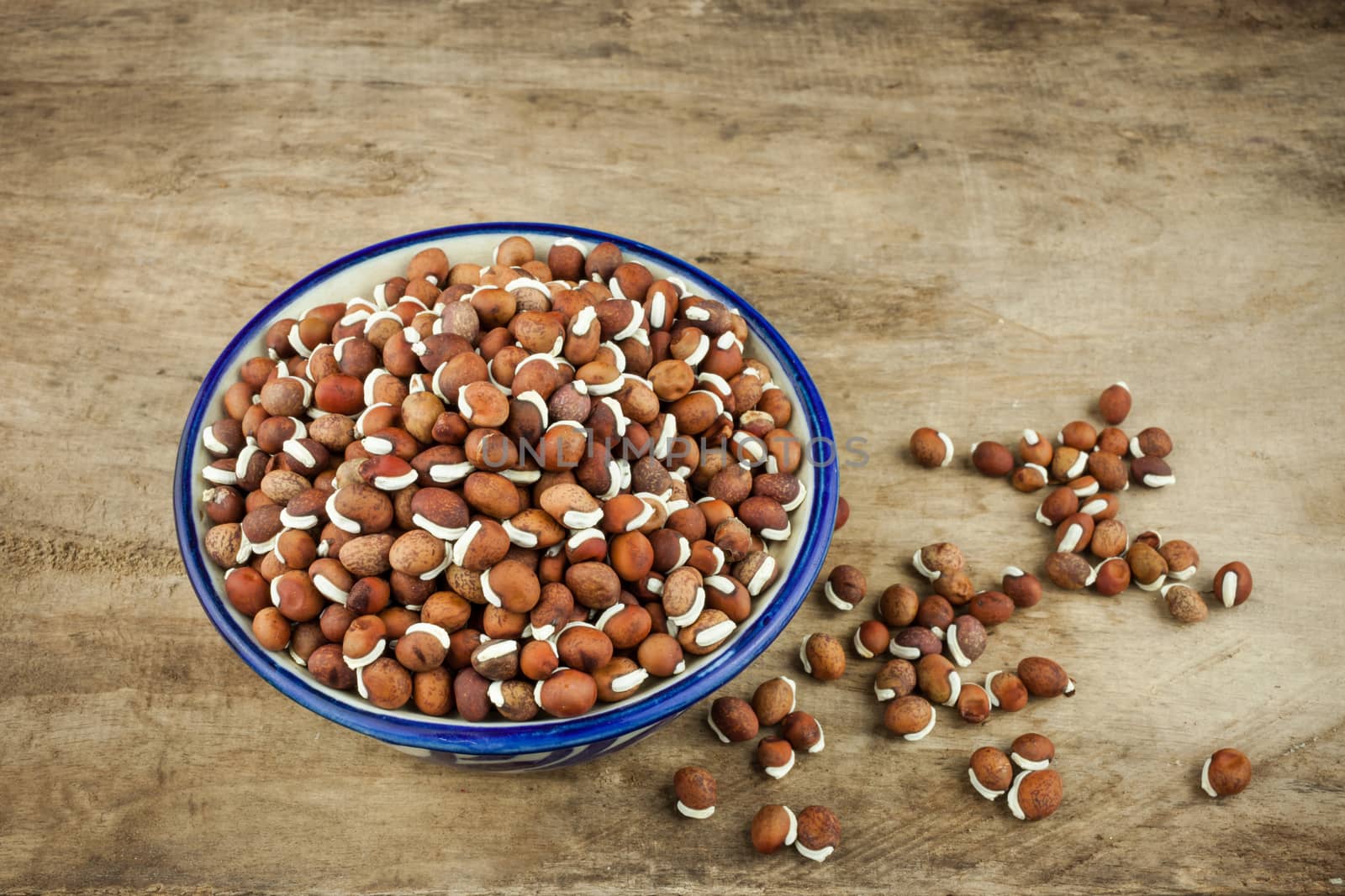 Portion of nature peas in bowls on wooden background.