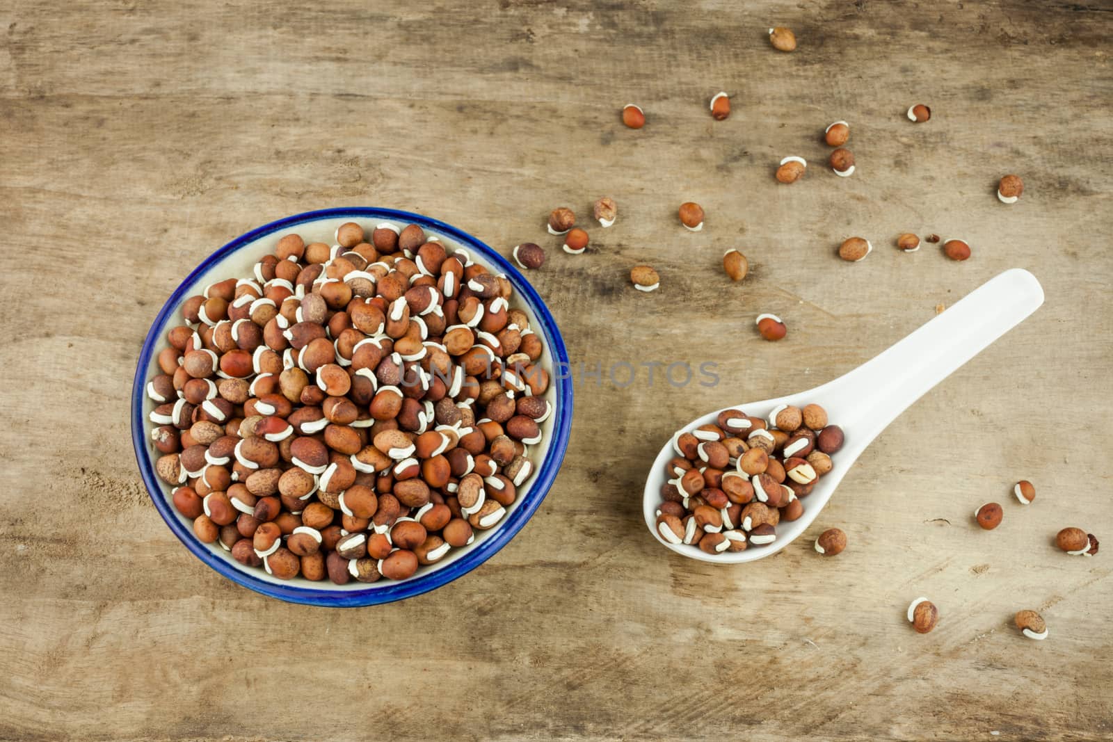 Portion of nature peas in bowls on wooden background.