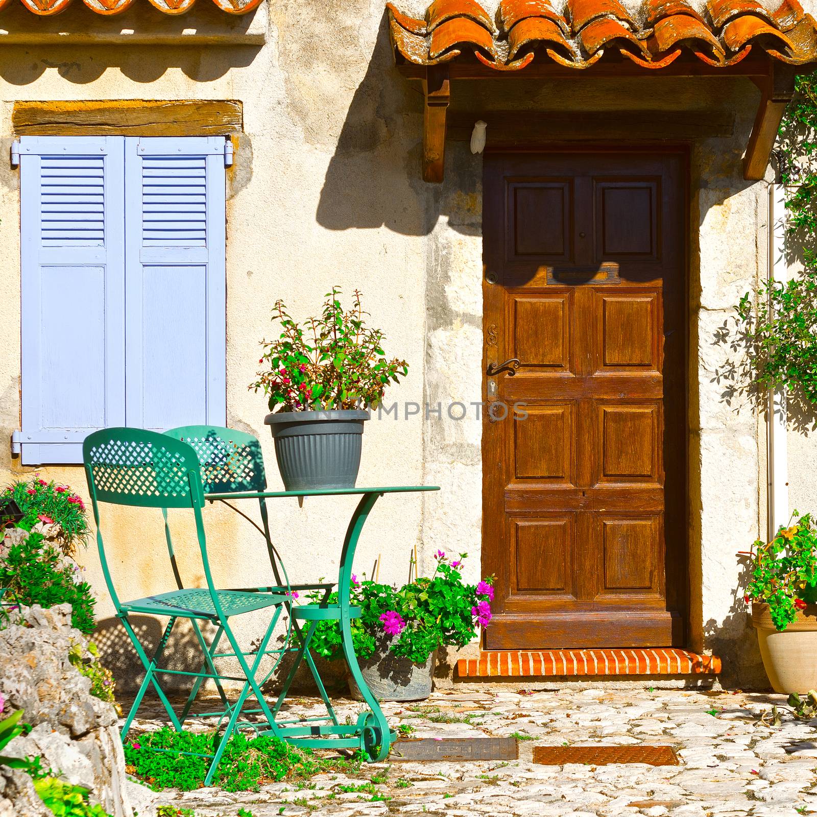  Facade of French House with Door and Window Decorated with Fresh Flowers