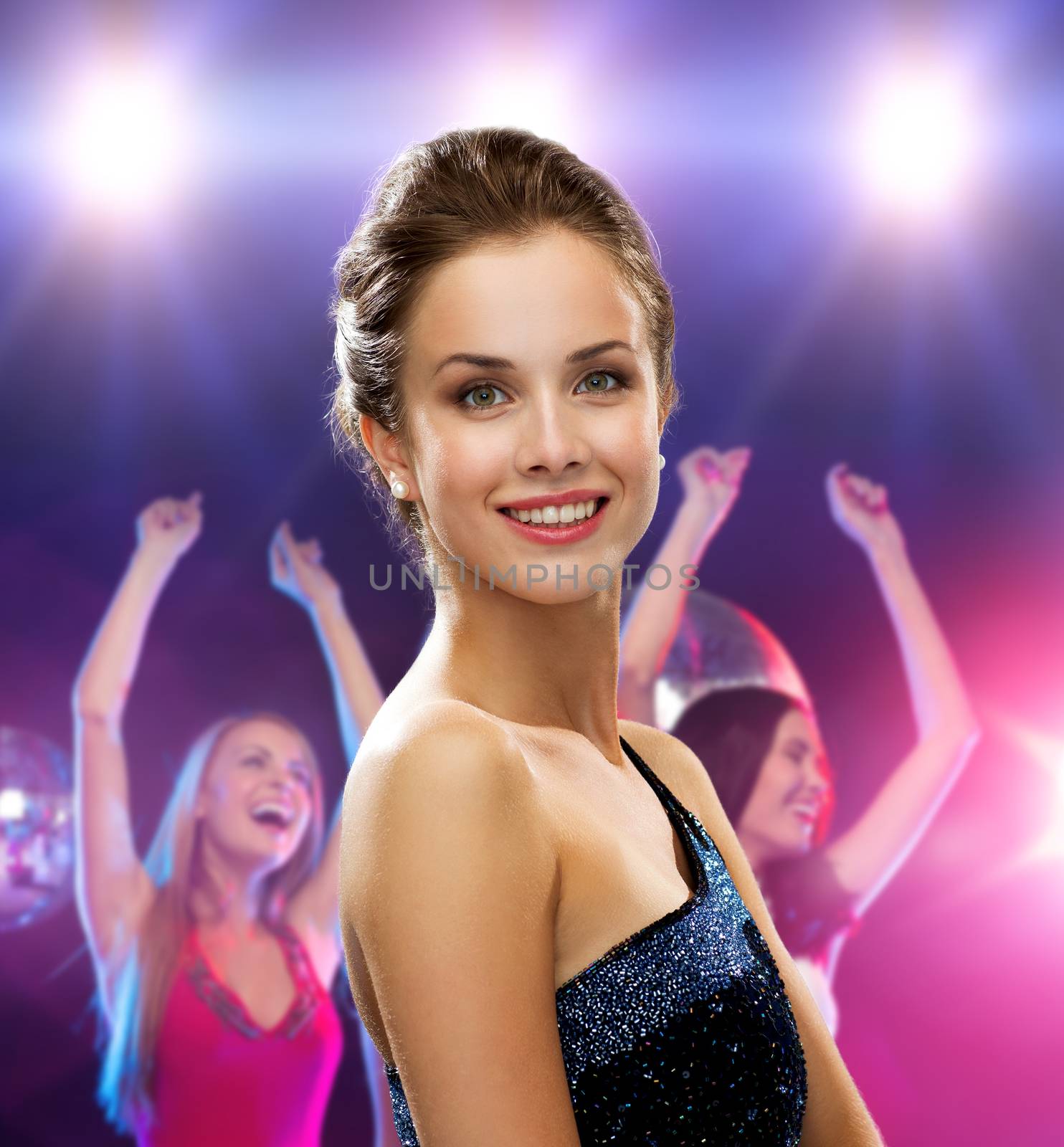 holidays, party and people concept - smiling woman in evening dress over disco background
