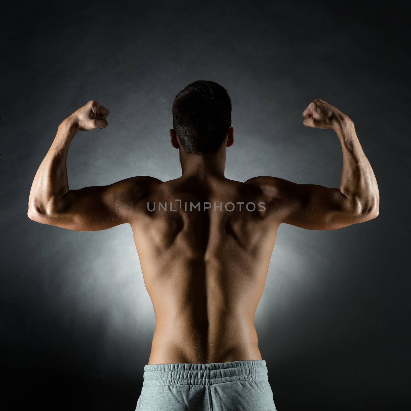 young man showing biceps by dolgachov
