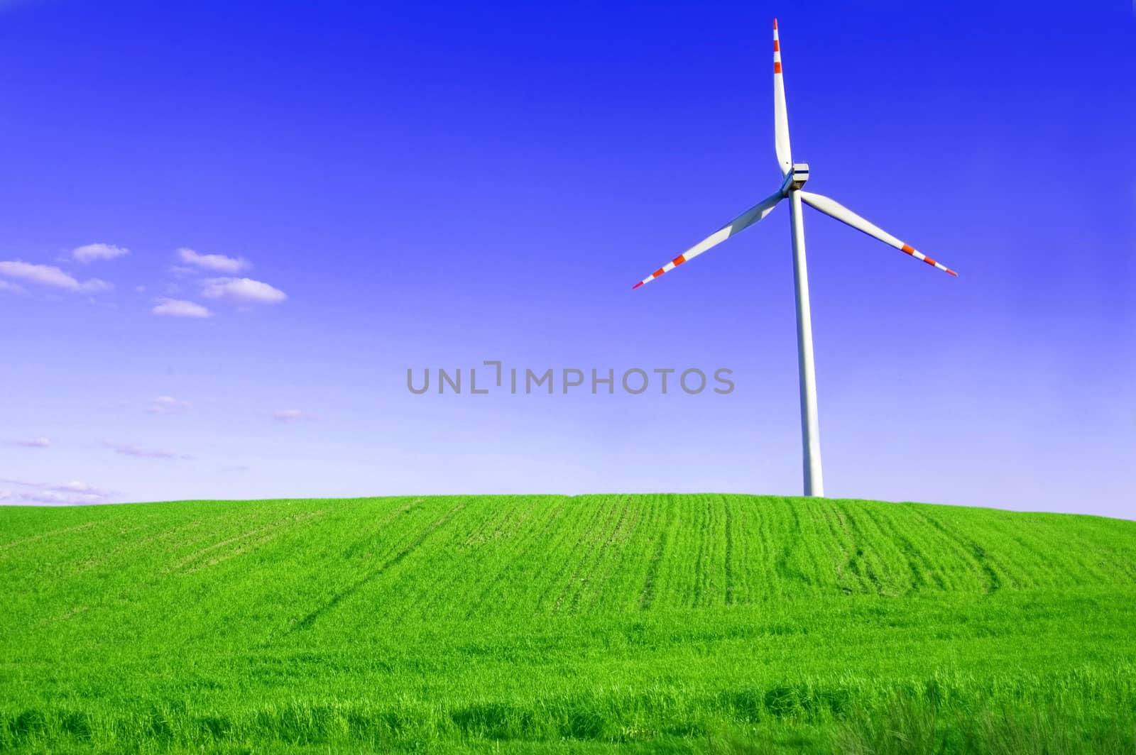 Windmill conceptual image. Windmill on the green field.