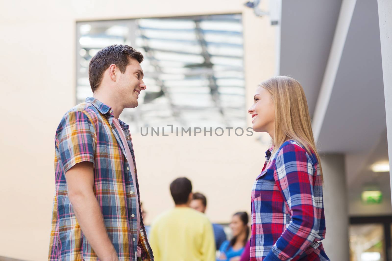 friendship, people and education concept - group of smiling students outdoors