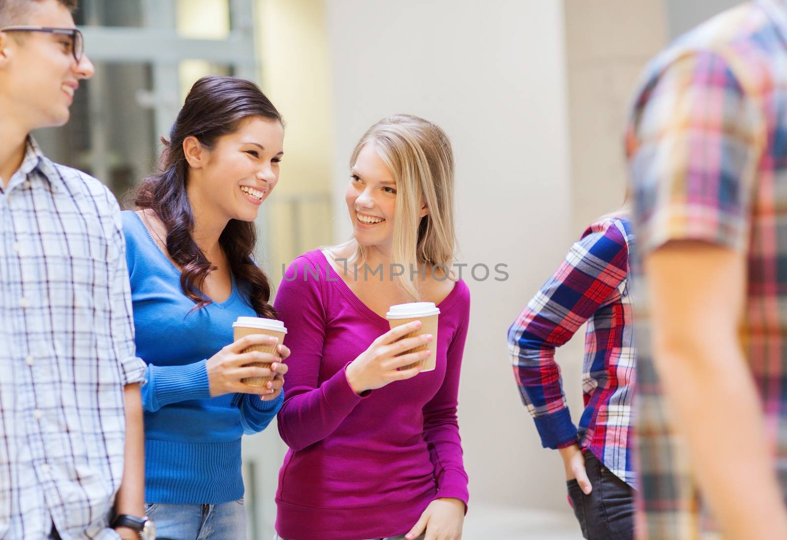 group of smiling students with paper coffee cups by dolgachov
