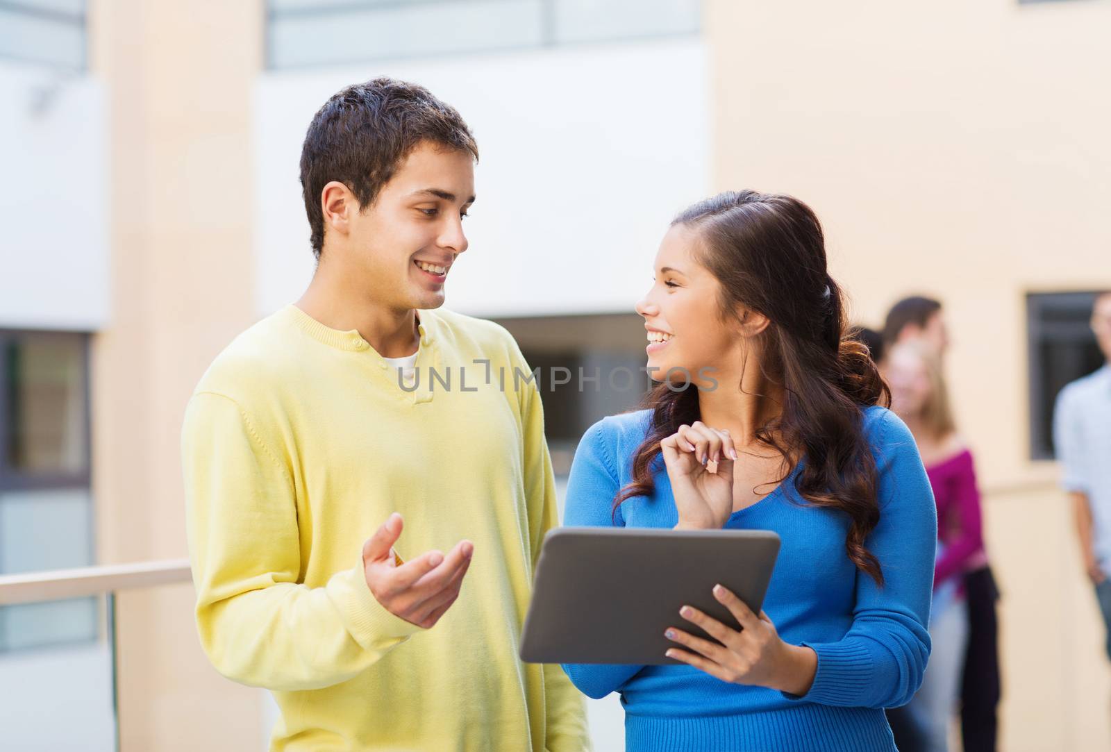 friendship, people, technology and education concept - group of smiling students with tablet pc computer outdoors
