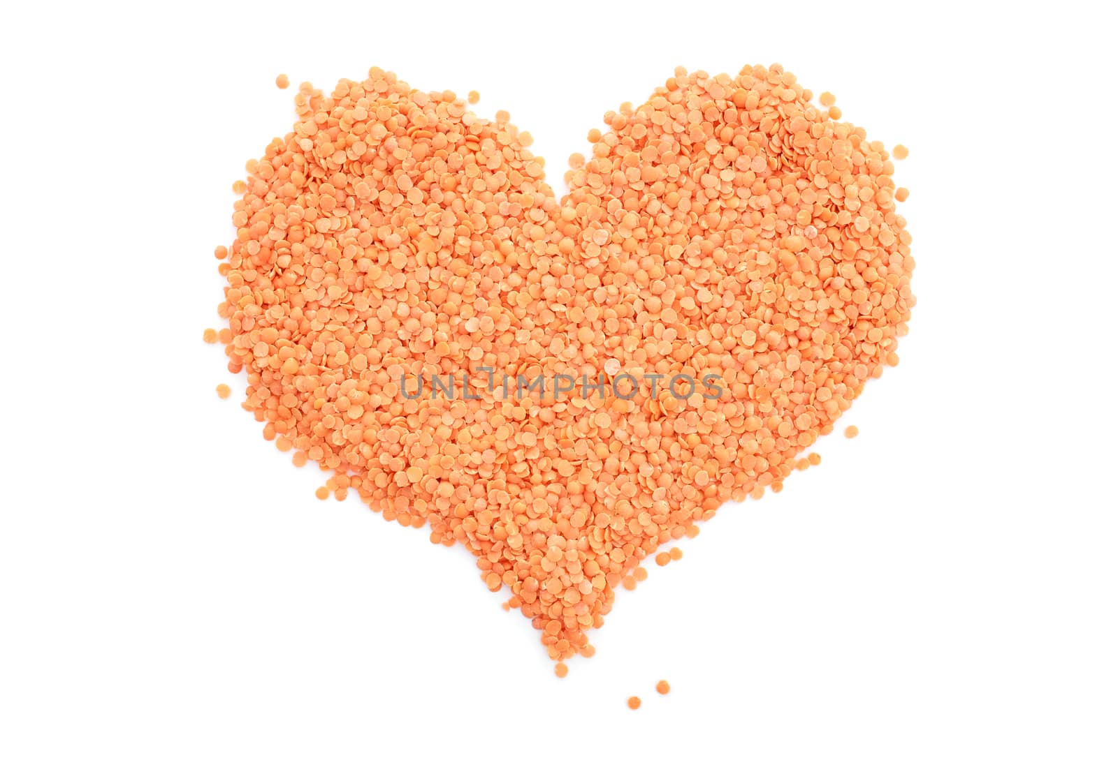Red lentils in a heart shape, isolated on a white background