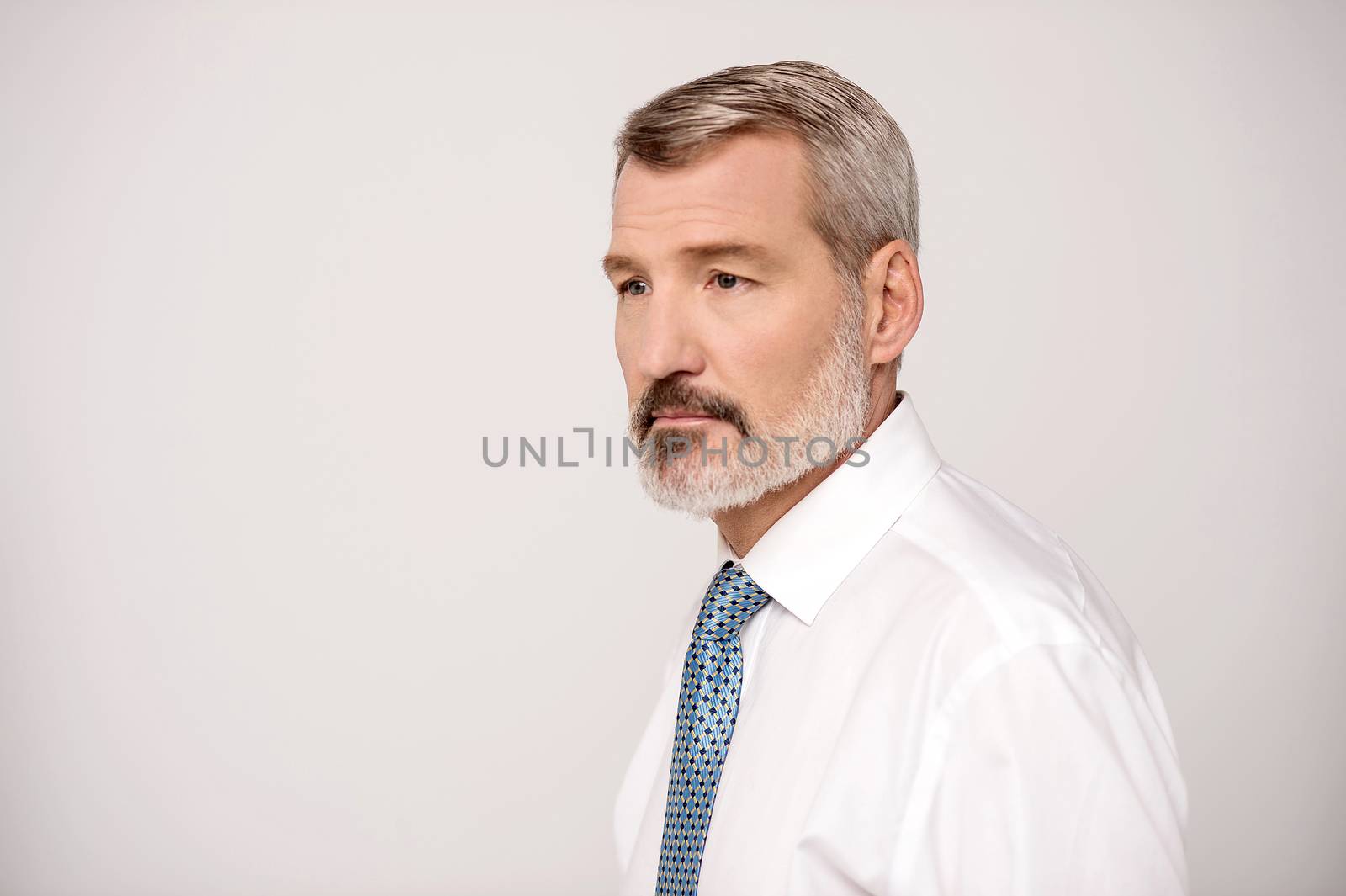 Portrait of a senior businessman isolated on grey background