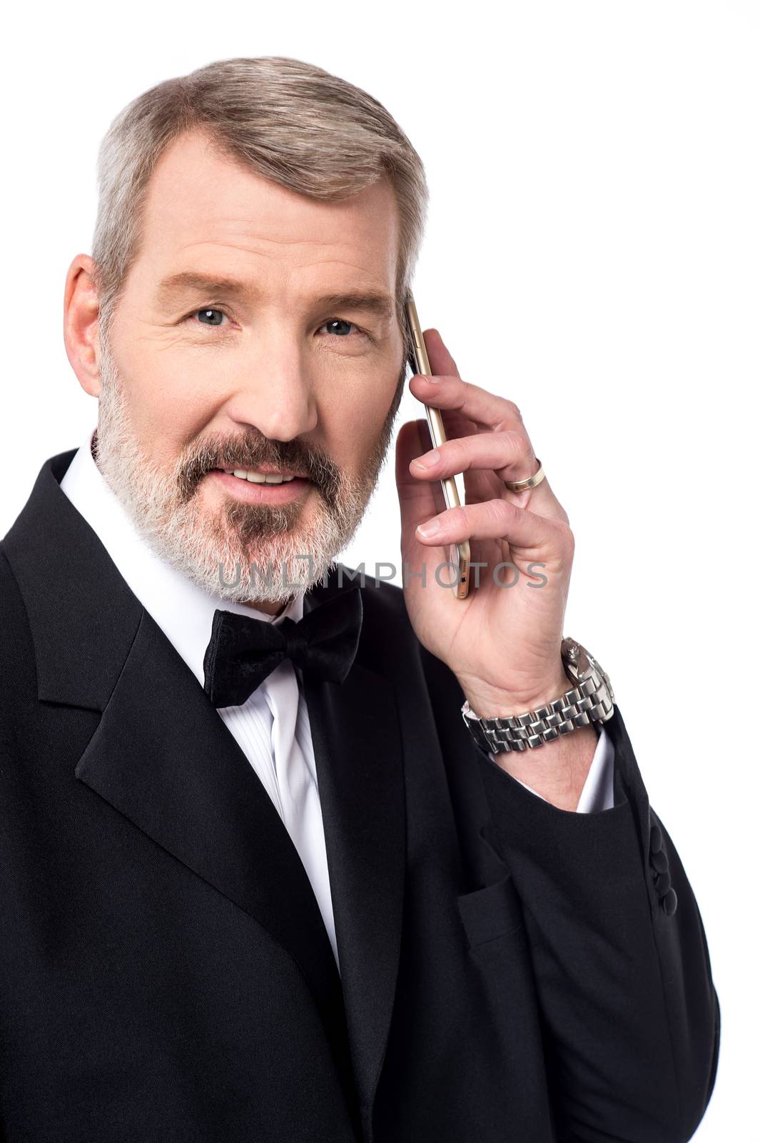 Mature man talking over the phone on white background