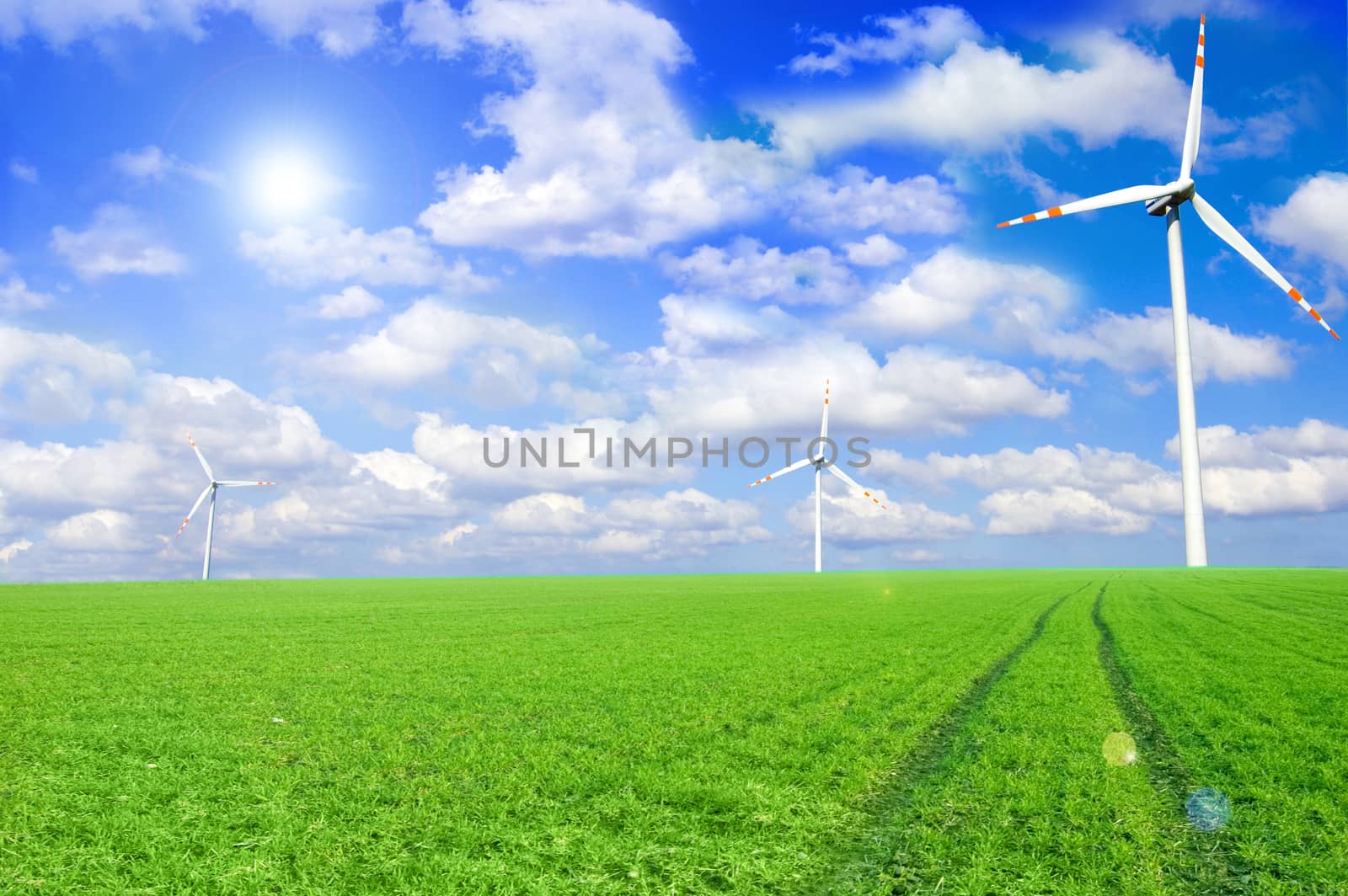 Windmill conceptual image. Windmills on the green field.