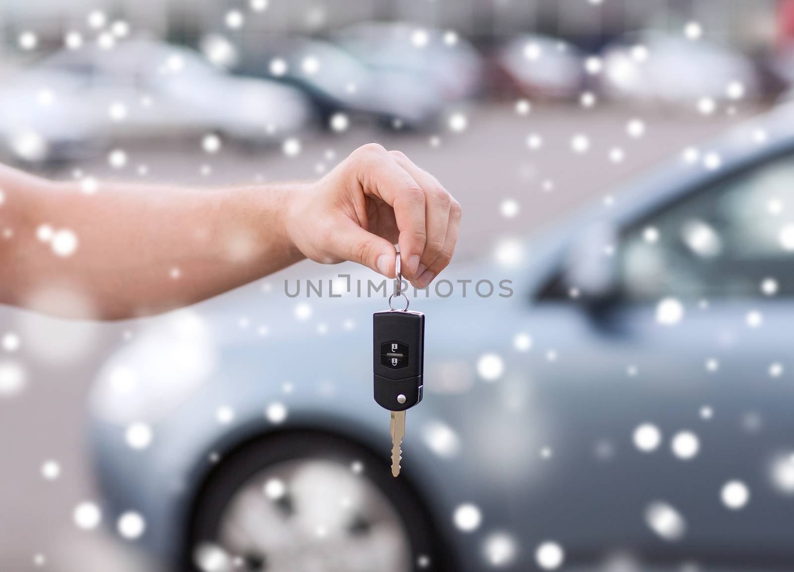 close up of man with car key outdoors by dolgachov