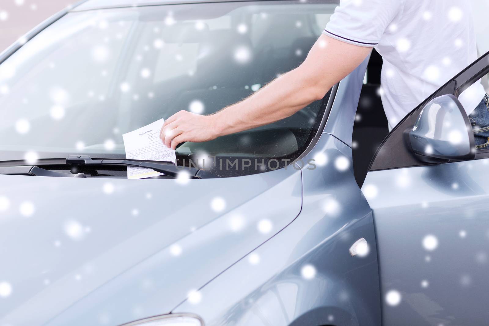 transportation and vehicle concept - close up of parking ticket on car windscreen