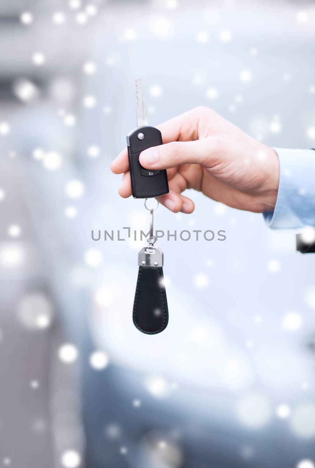 close up of man with car key outdoors by dolgachov