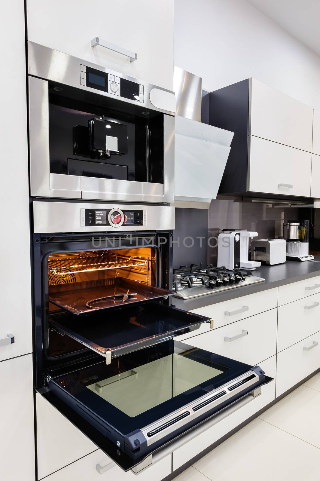 Modern luxury custom hi-tek black and white kitchen, clean interior design, focus at oven with open door