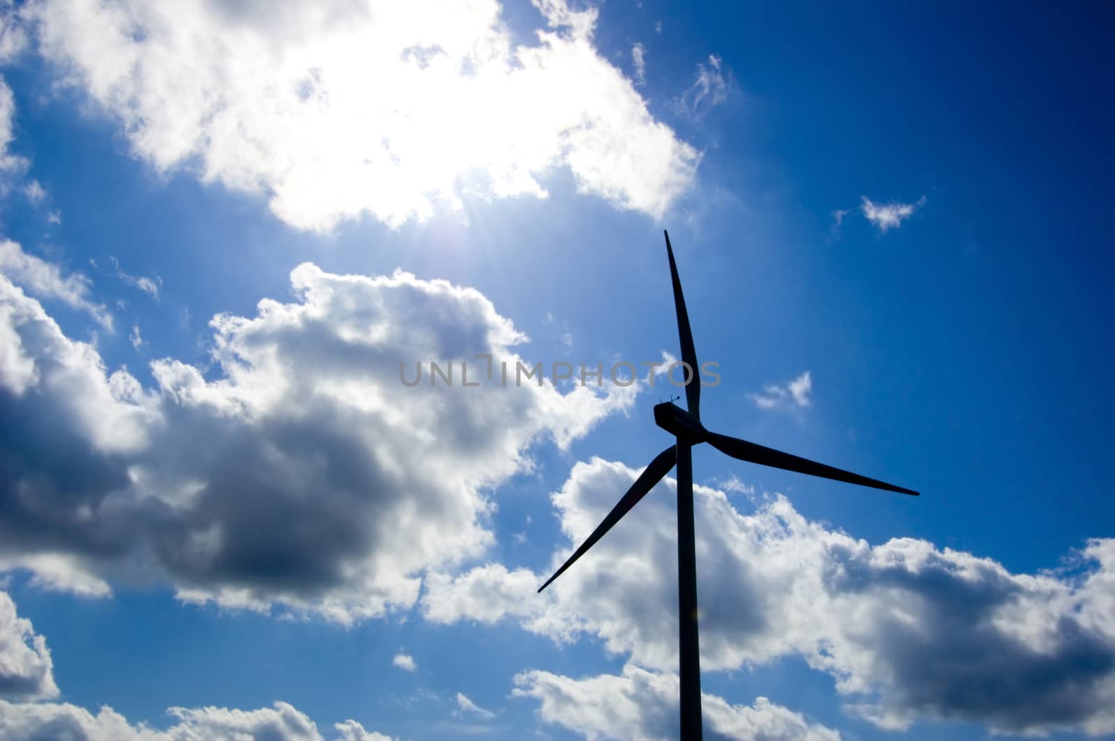 Windmill conceptual image. Close up of a windmill against the blue sky.