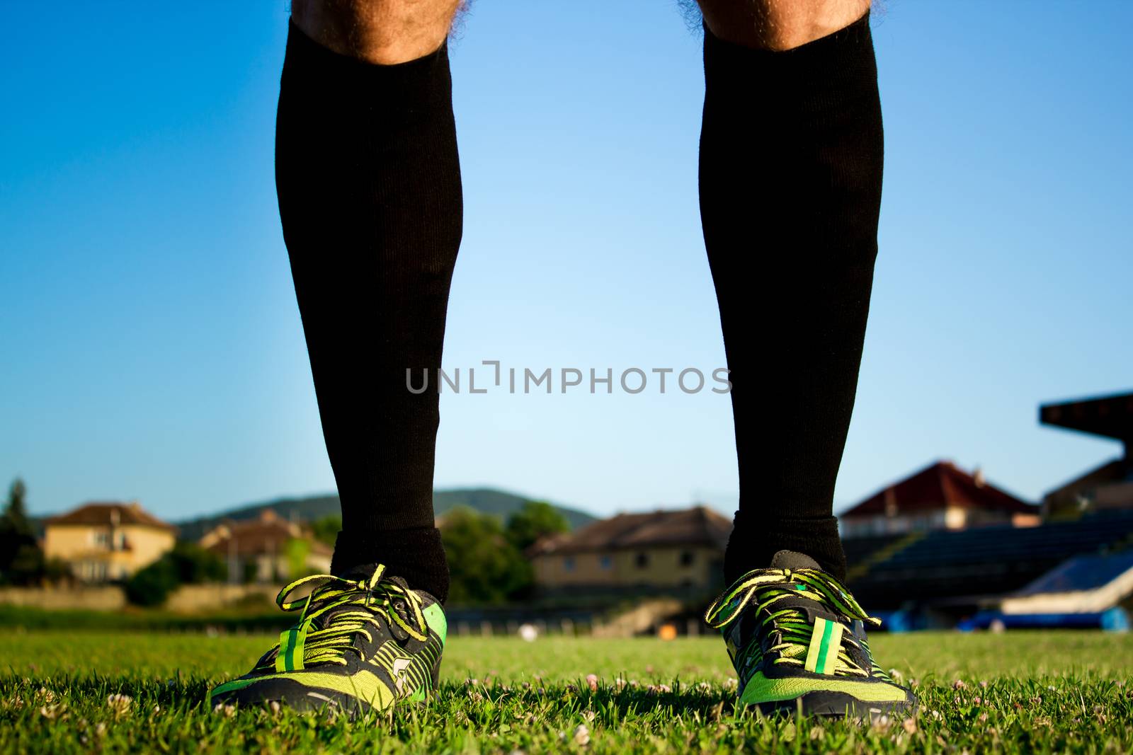 Soccer player posing on a stadium