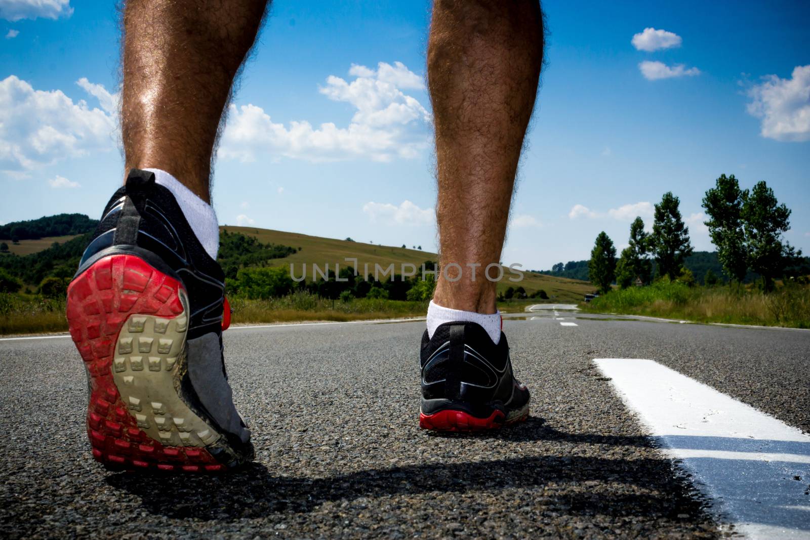 Runner getting ready to run on a street in the middle of nowhere