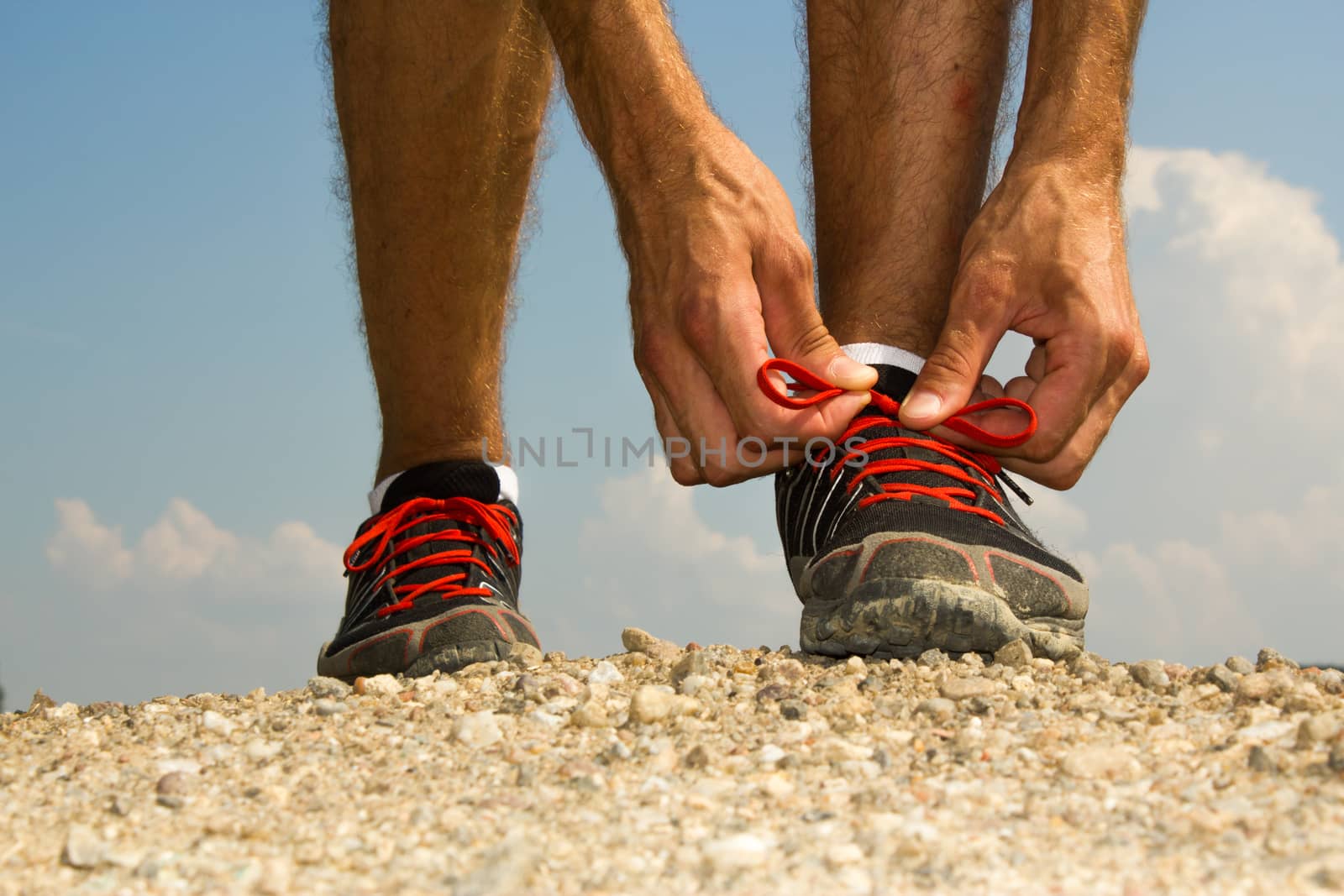 Runner tying shoelaces by Madrolly