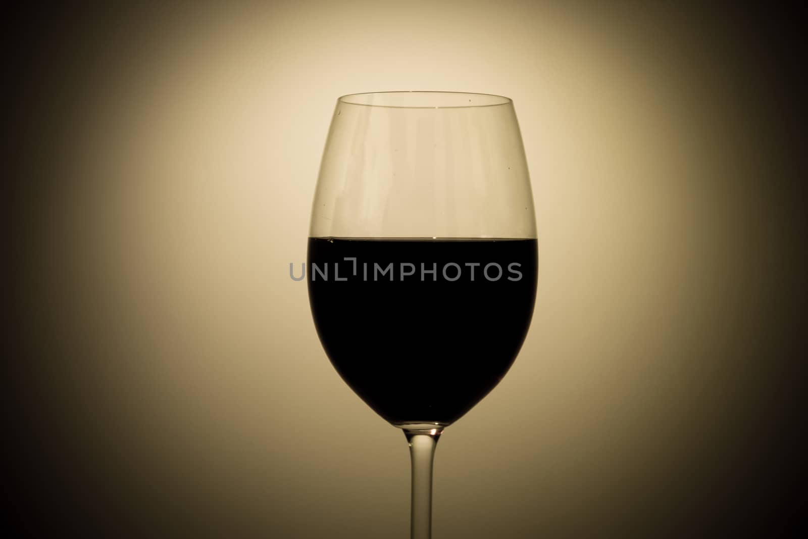 A red glass of wine on a dark background