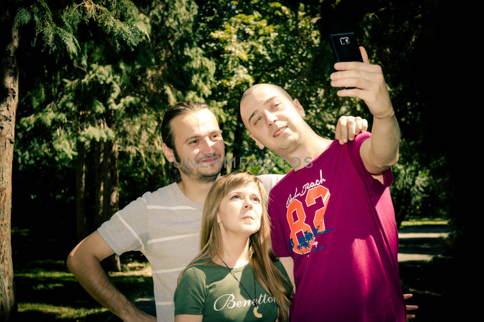 Friends group taking a selfie in the park