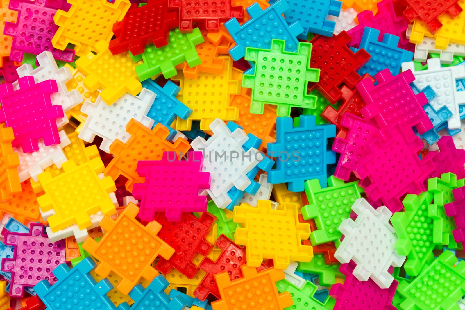 Some colorful jigsaw puzzle pieces close up.