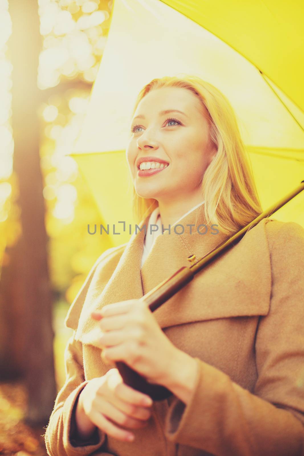woman with yellow umbrella in the autumn park by dolgachov