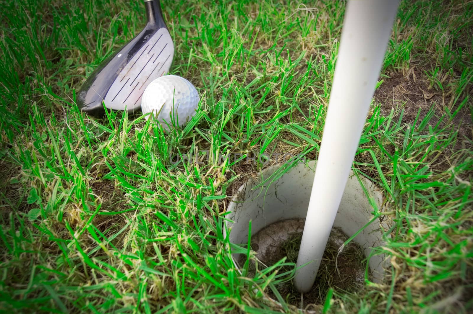 Golf game. Golf ball hit by a golf club.