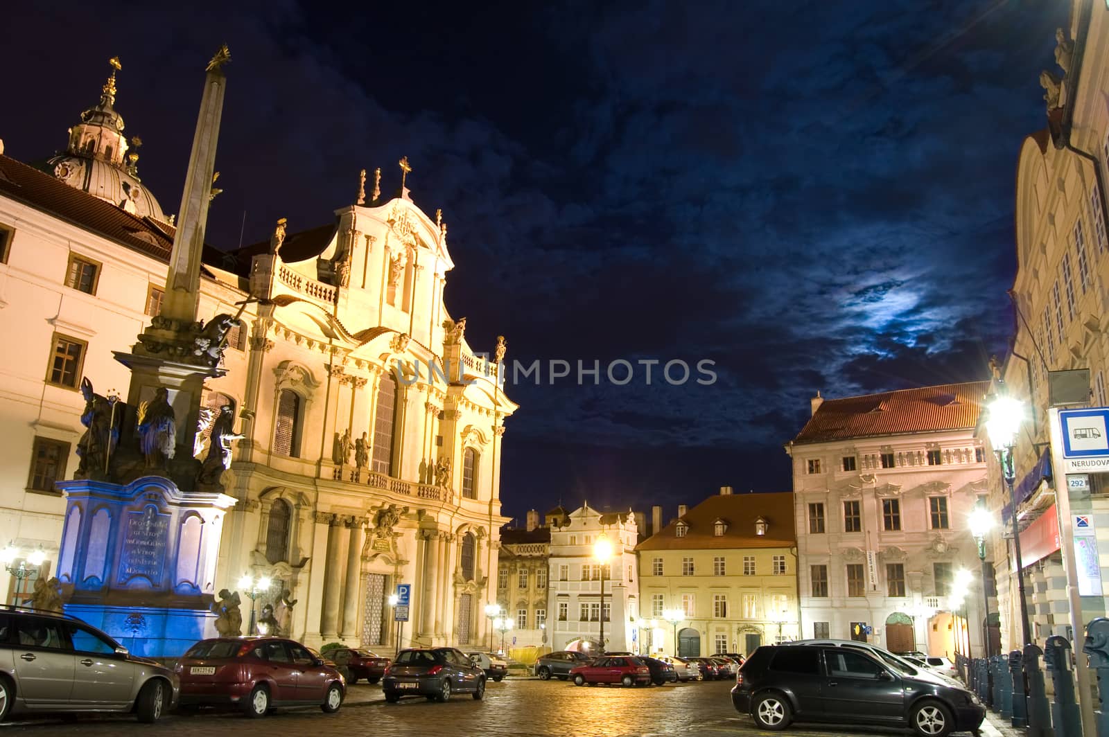 Street at night in Prague with church.