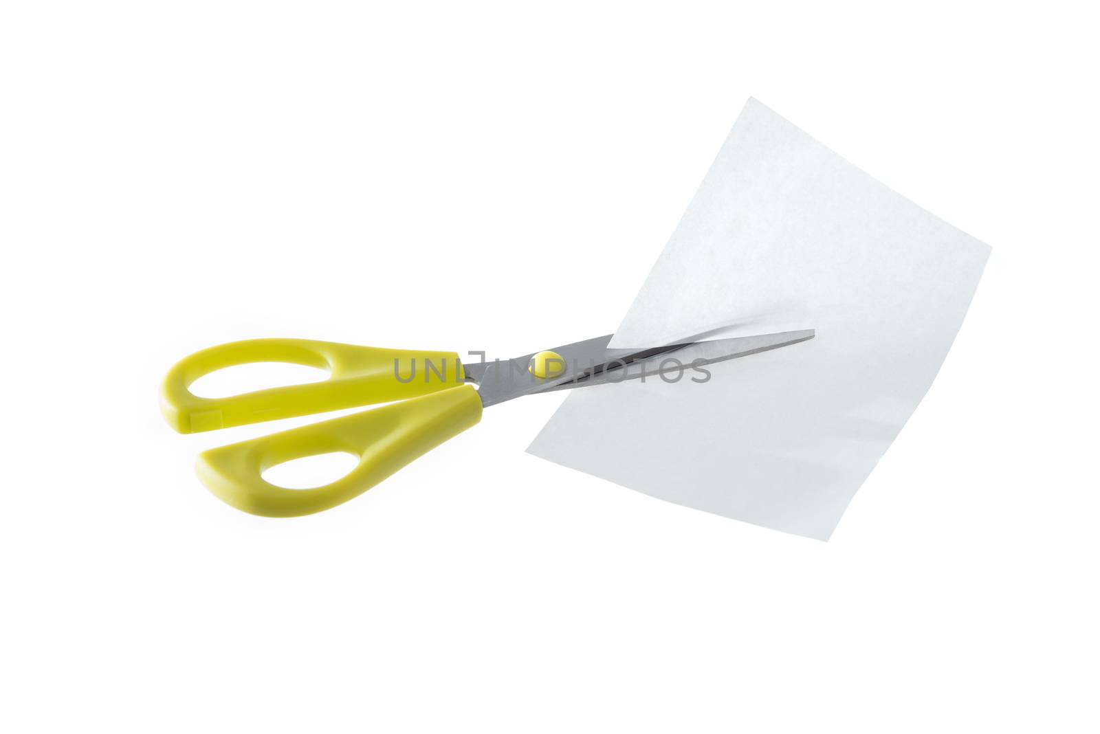 A pair of yellow scissors cutting a piece of white paper isolated on a white background.