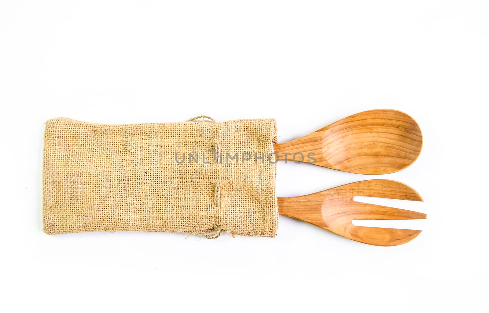 Wooden spoon and fork on sack surface.Isolated on white background.