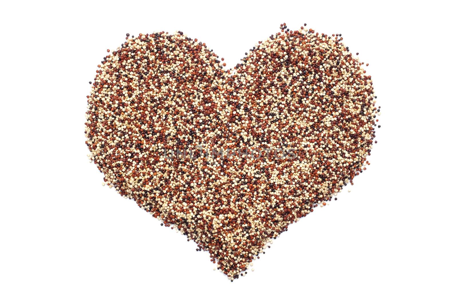 Mixed quinoa in a heart shape, isolated on a white background