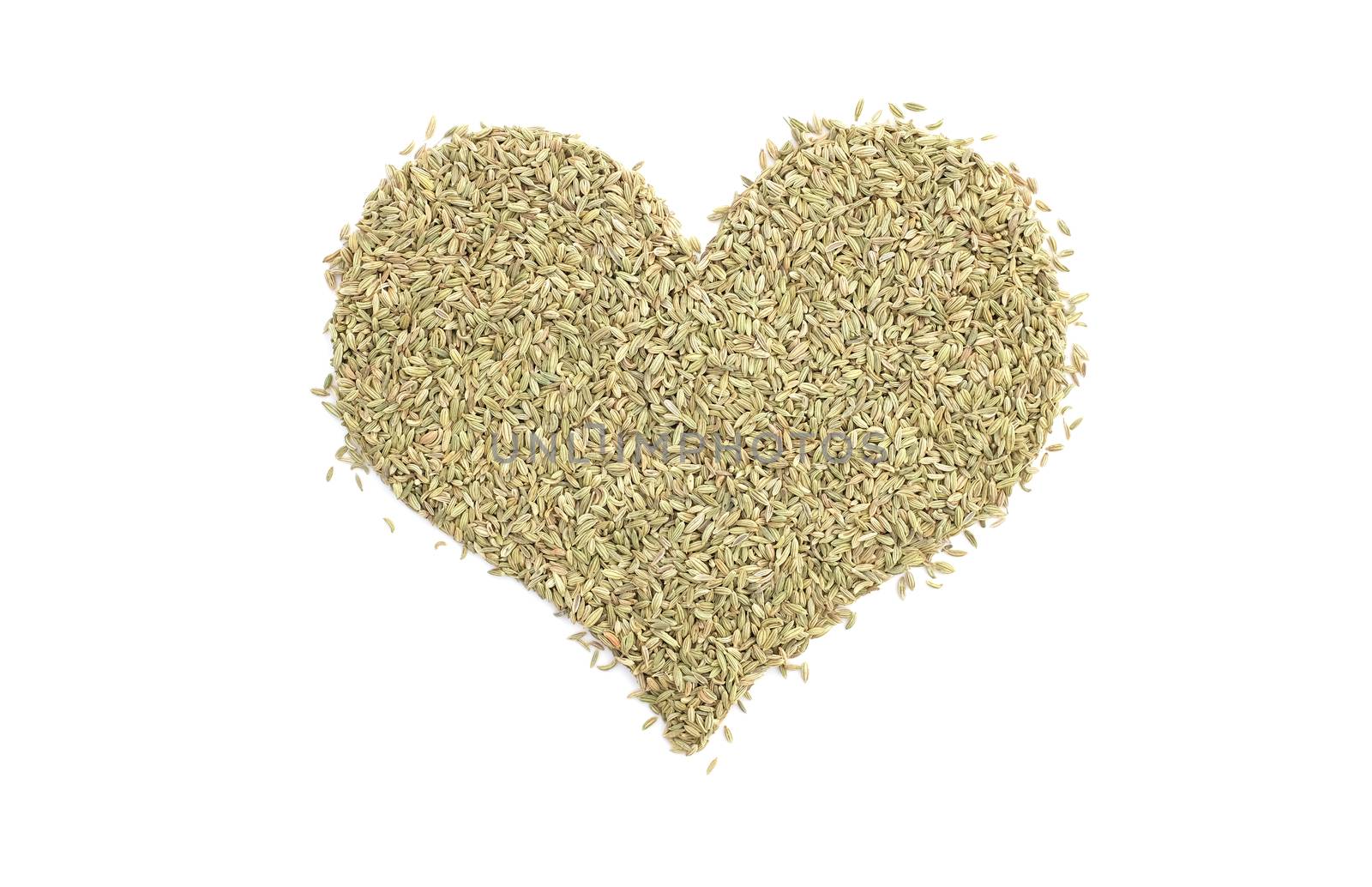 Fennel seeds in a heart shape, isolated on a white background