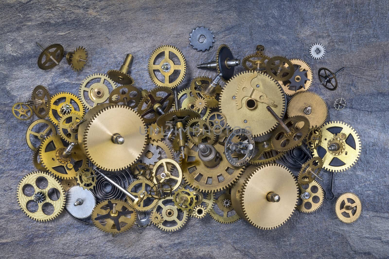 Selection of dusty old brass clock parts.