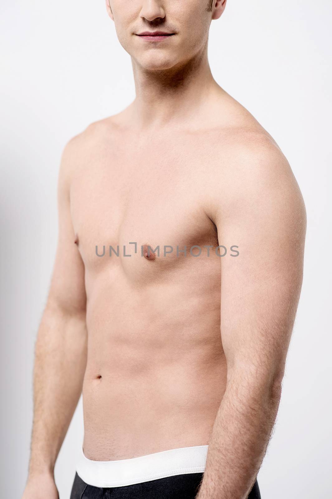Cropped image of shirtless young male posing