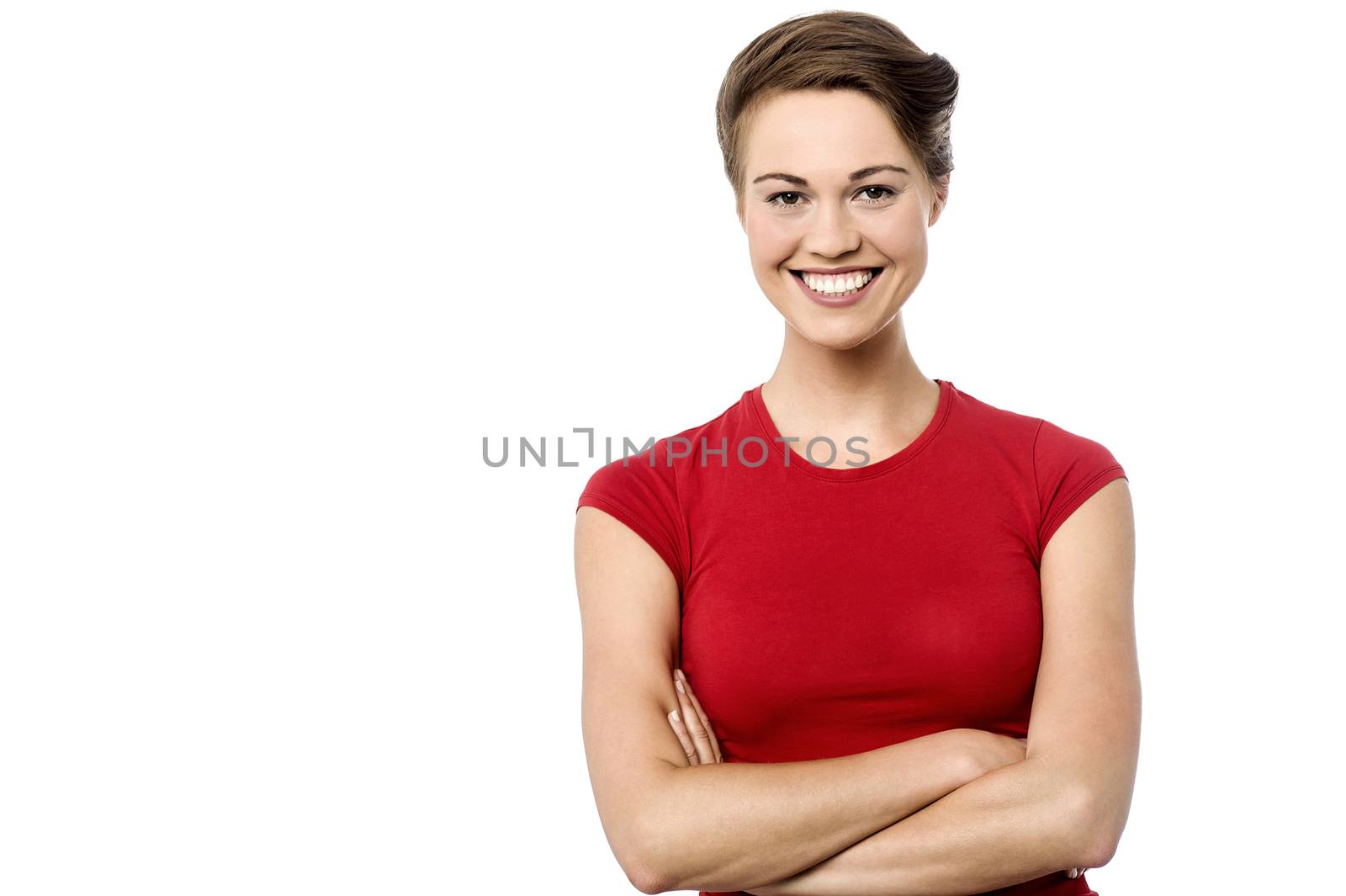 Happy young woman posing with folded arms