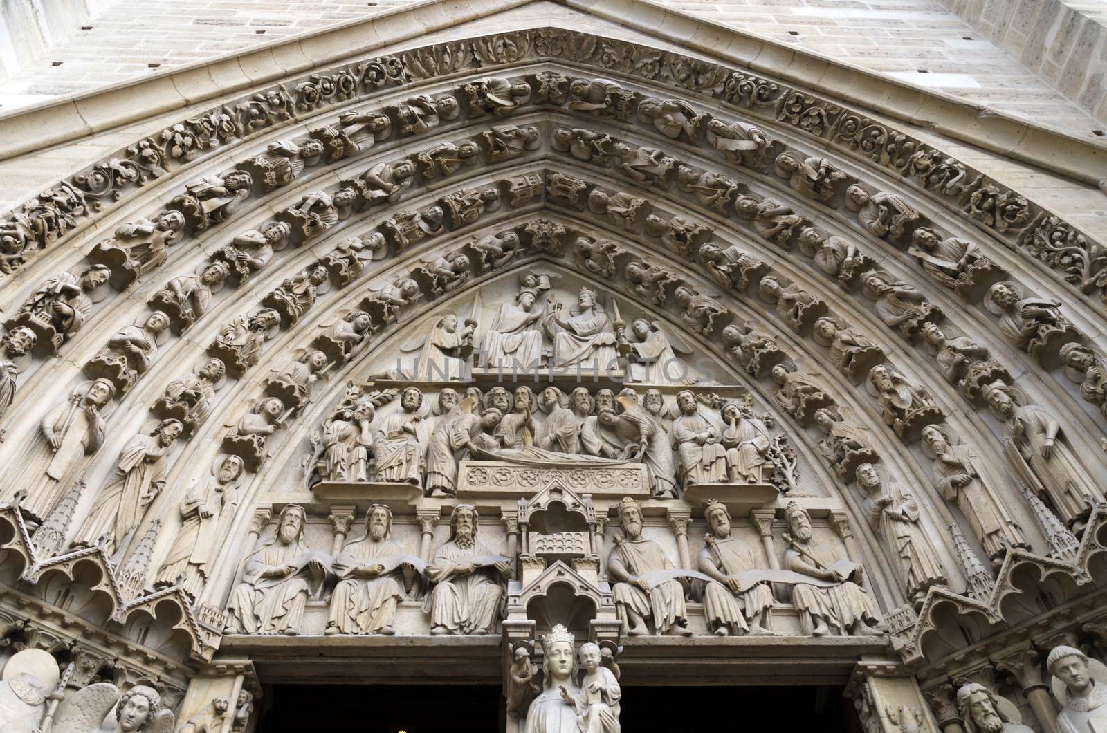 Famous Notre Dame cathedral facade saint statues in Paris, France. UNESCO World Heritage Site.