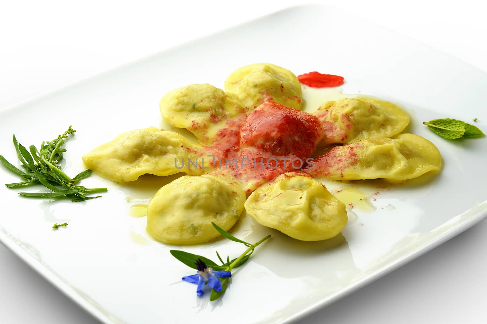 Pasta Dish Ravioli Stuffed with Shellfish and Sauce Wild Berries in square white plate