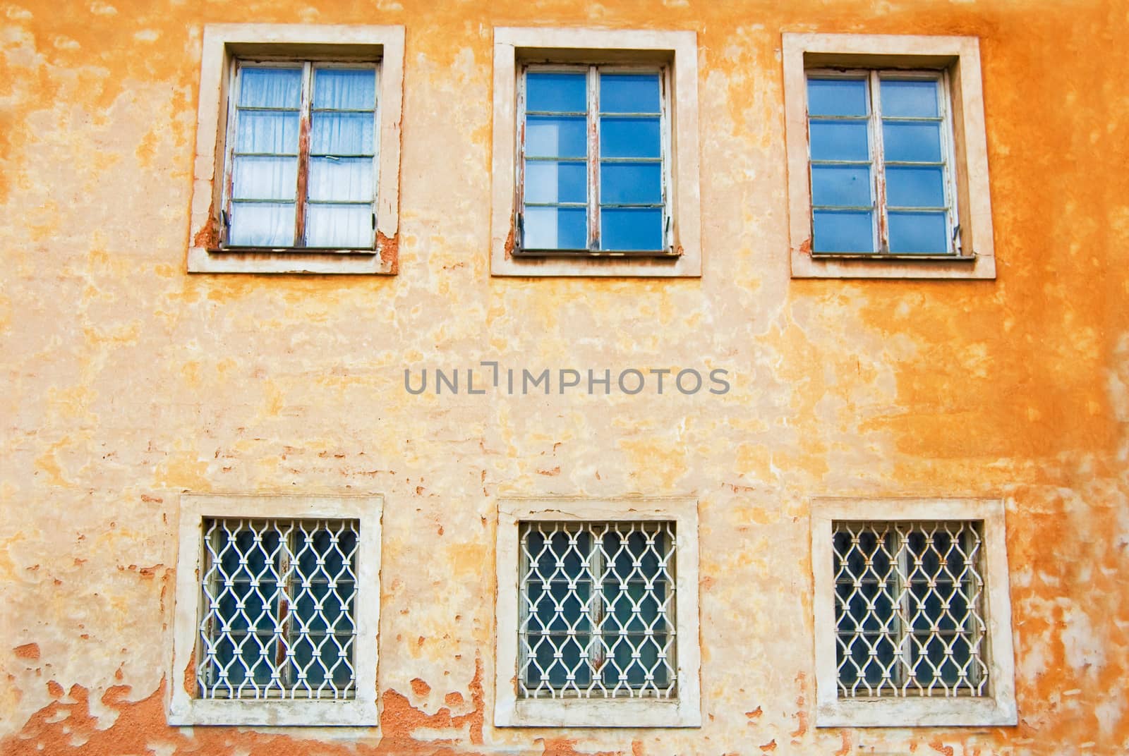 Windows in old orange house.