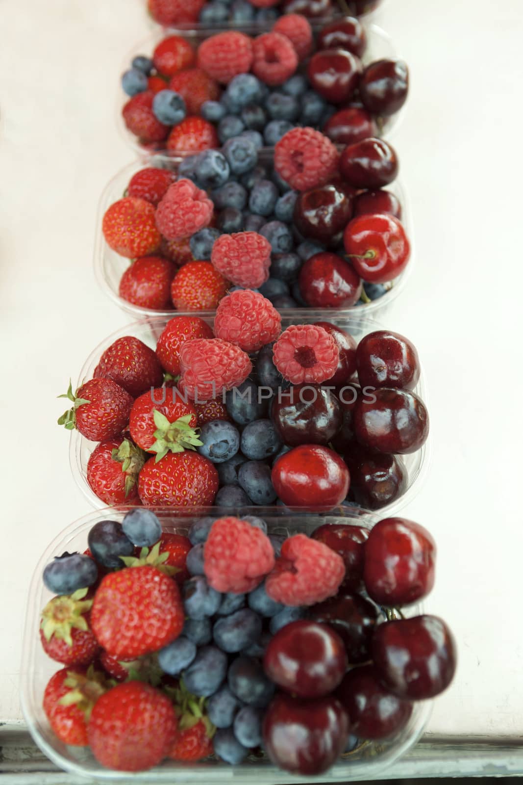 Fresh , raspberries, strawberries, cherries, blueberries in the box on the market by mcherevan