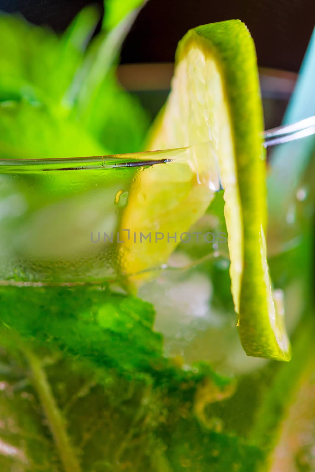 lemon lime slice on the glass with a cocktail macro