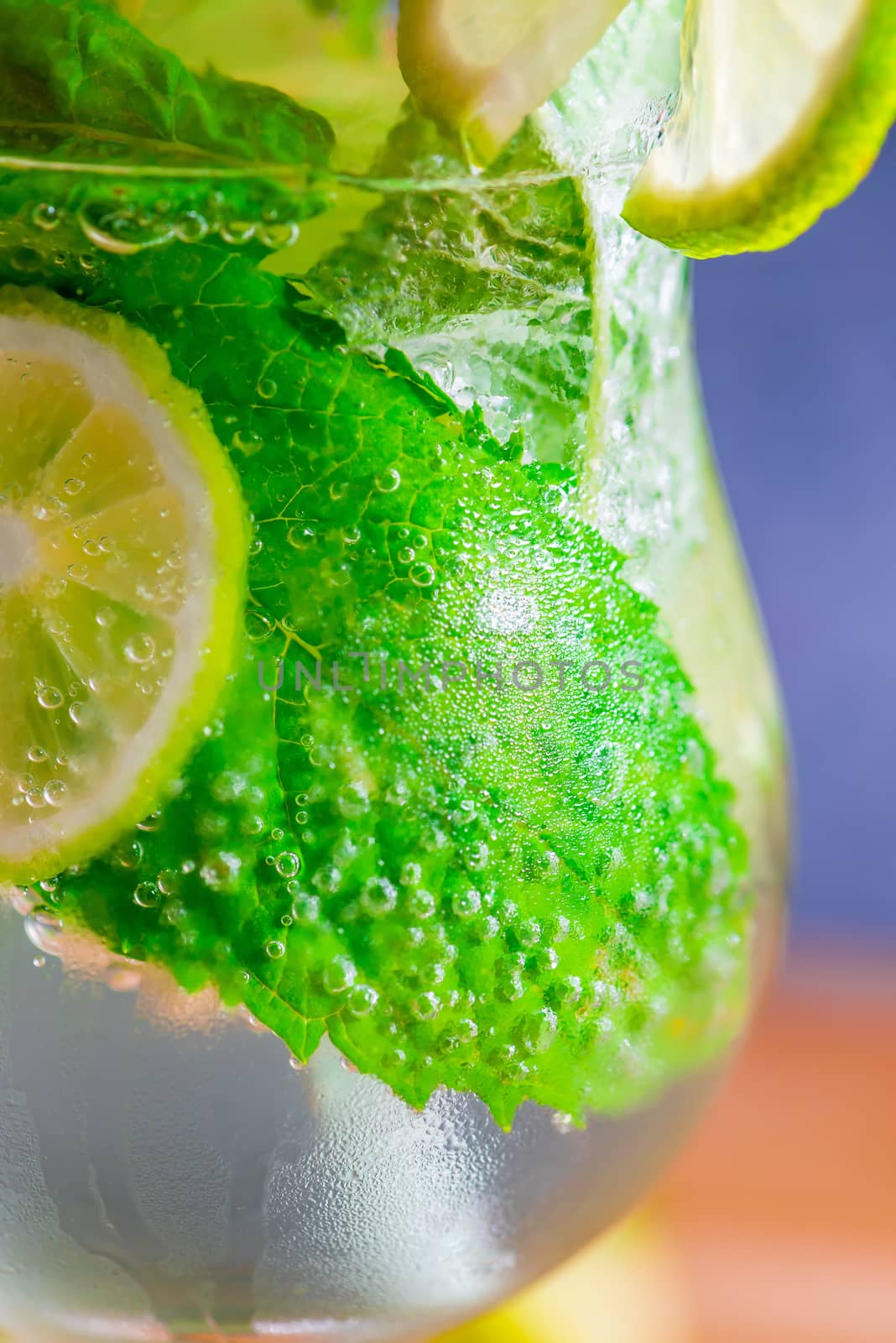 fizzy cold mojito cocktail in a glass closeup by kosmsos111
