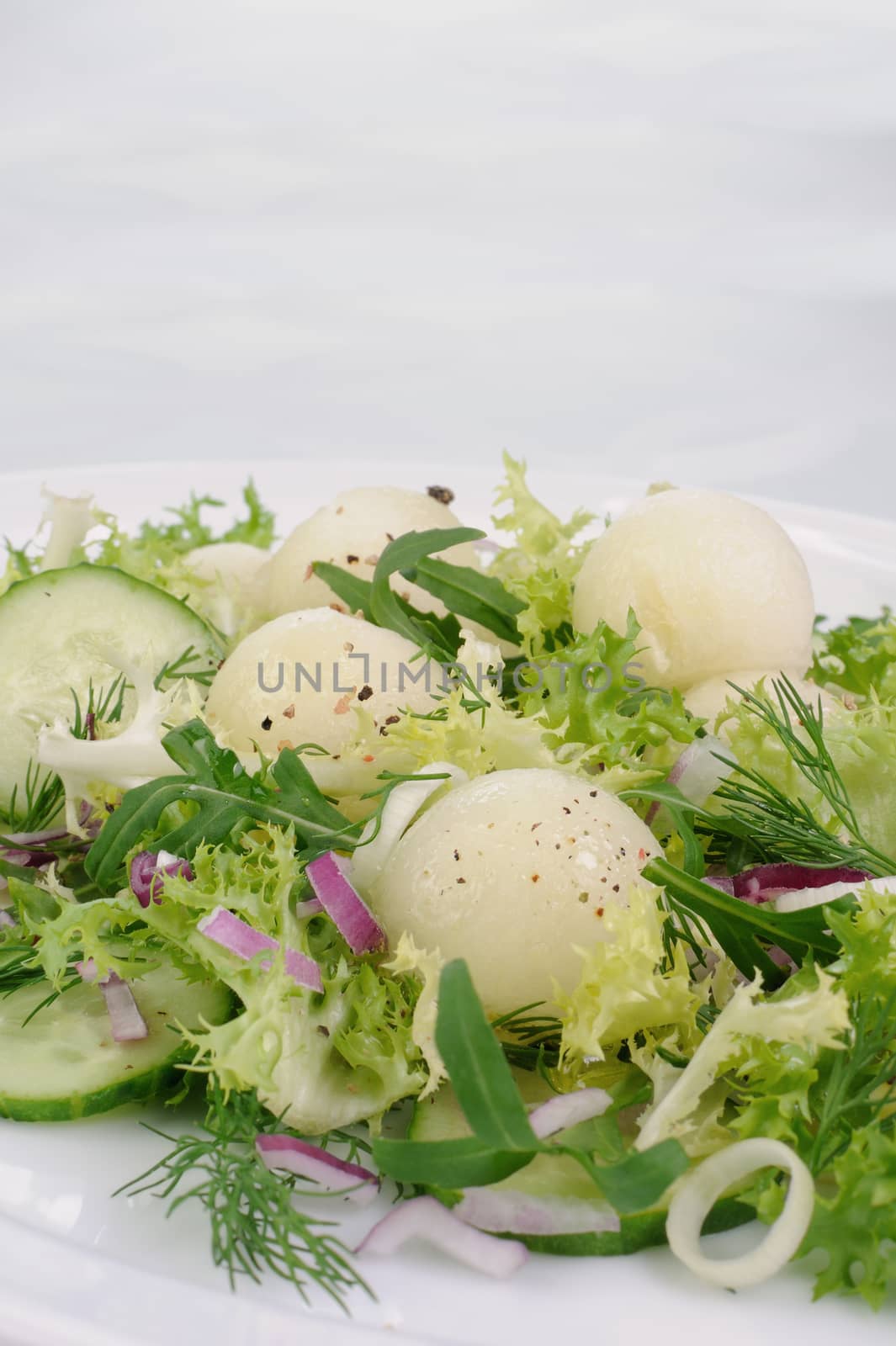Arugula salad with cucumber with melon balls