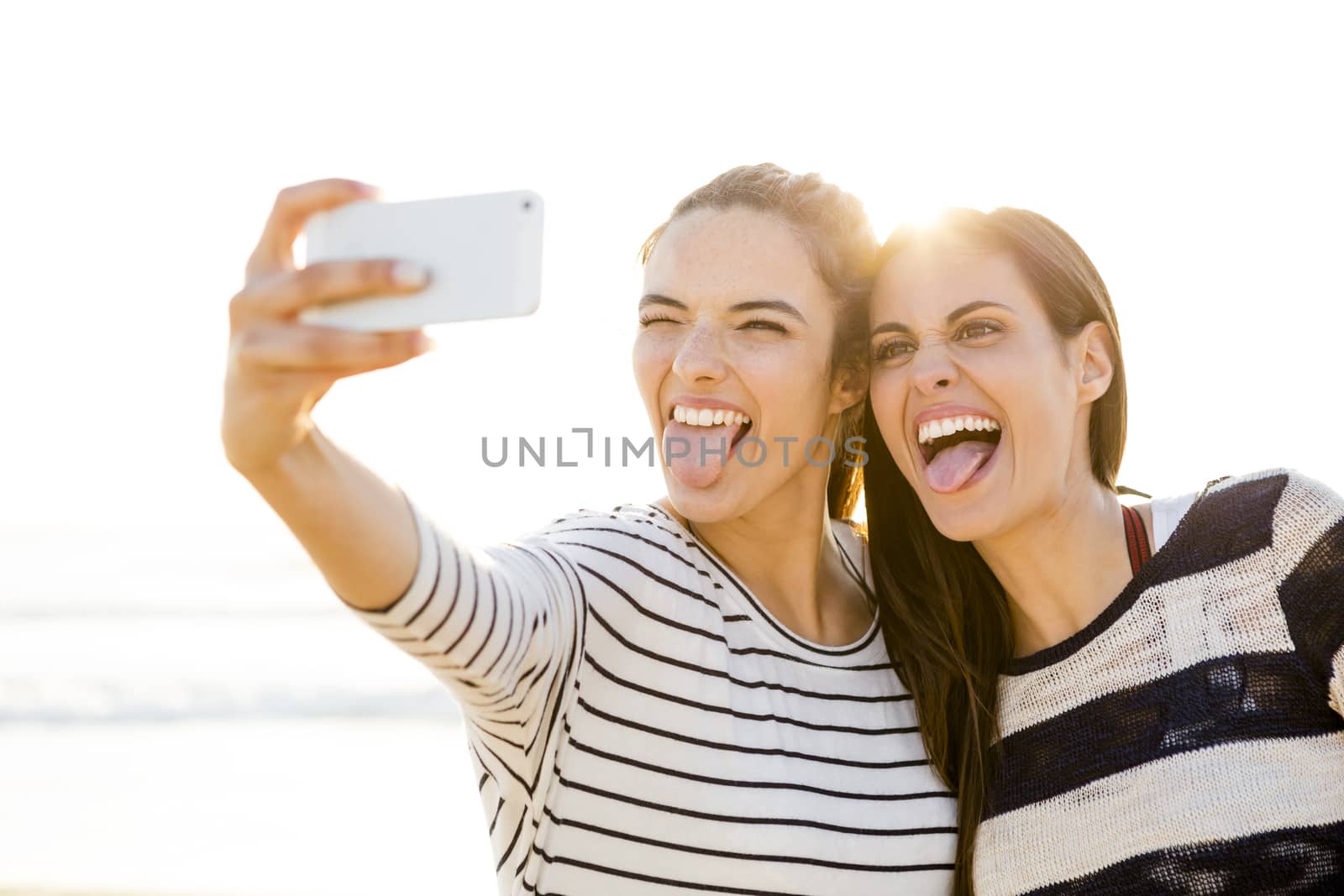 Two best friends taking a selfie with cellphone