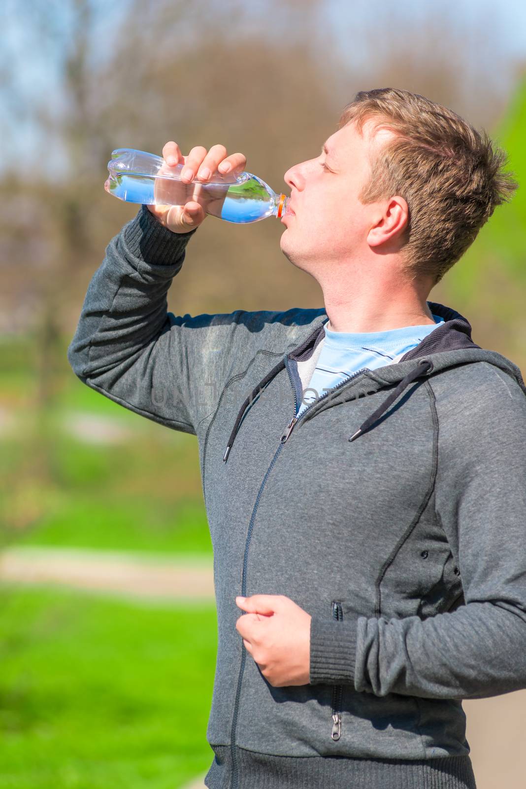 a young man with a bottle of water