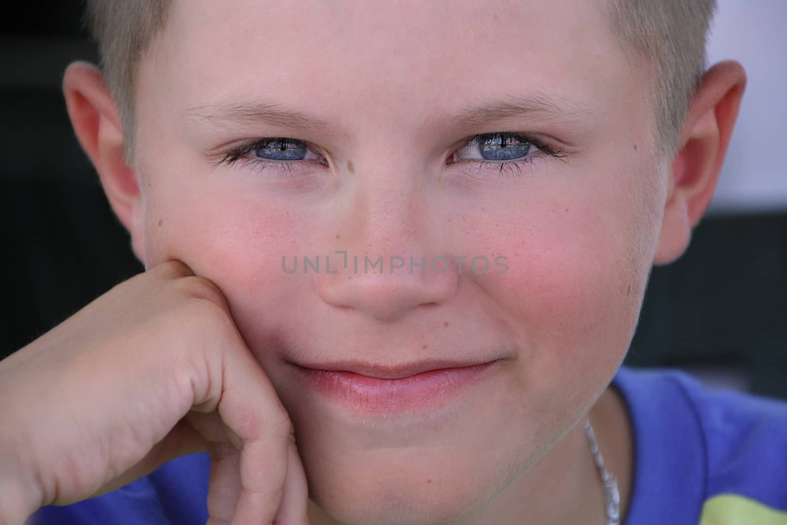 Closeup portrait of a charming blue-eyed boy who smiles