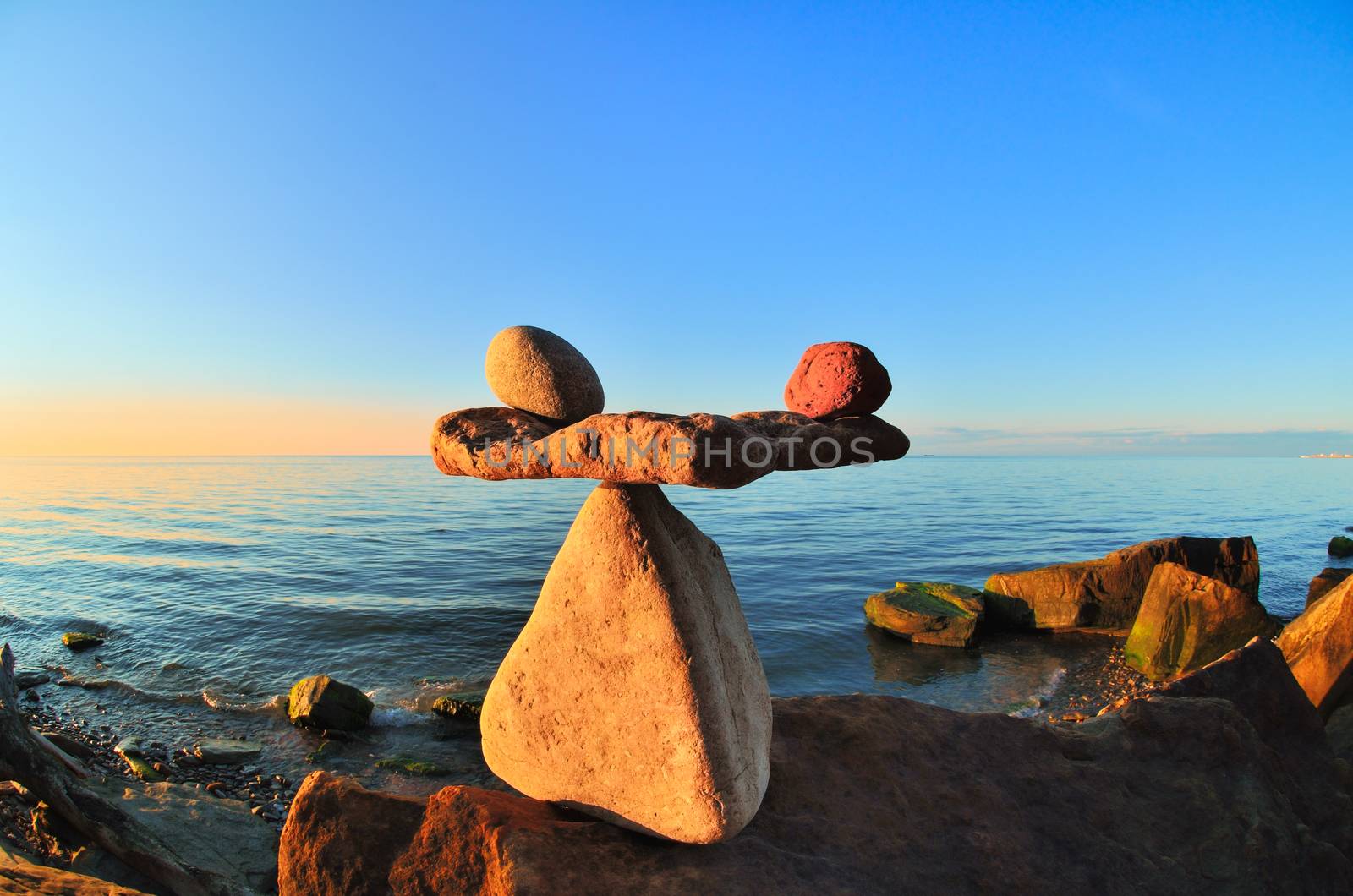 Symbol of scales is made of pebbles on the stony seashore