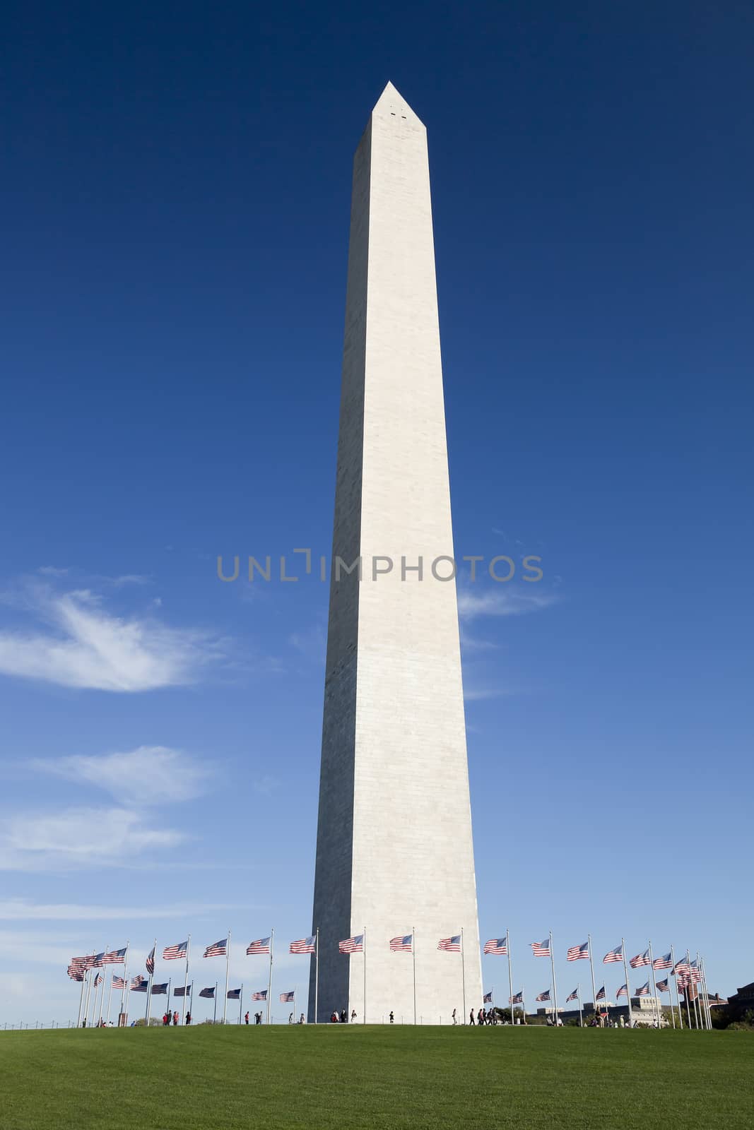 WASHINGTON, D.C. - OCTOBER 17, 2014: People enjoy sunny day at the Washington Monument. It is an obelisk built to commemorate George Washington.
