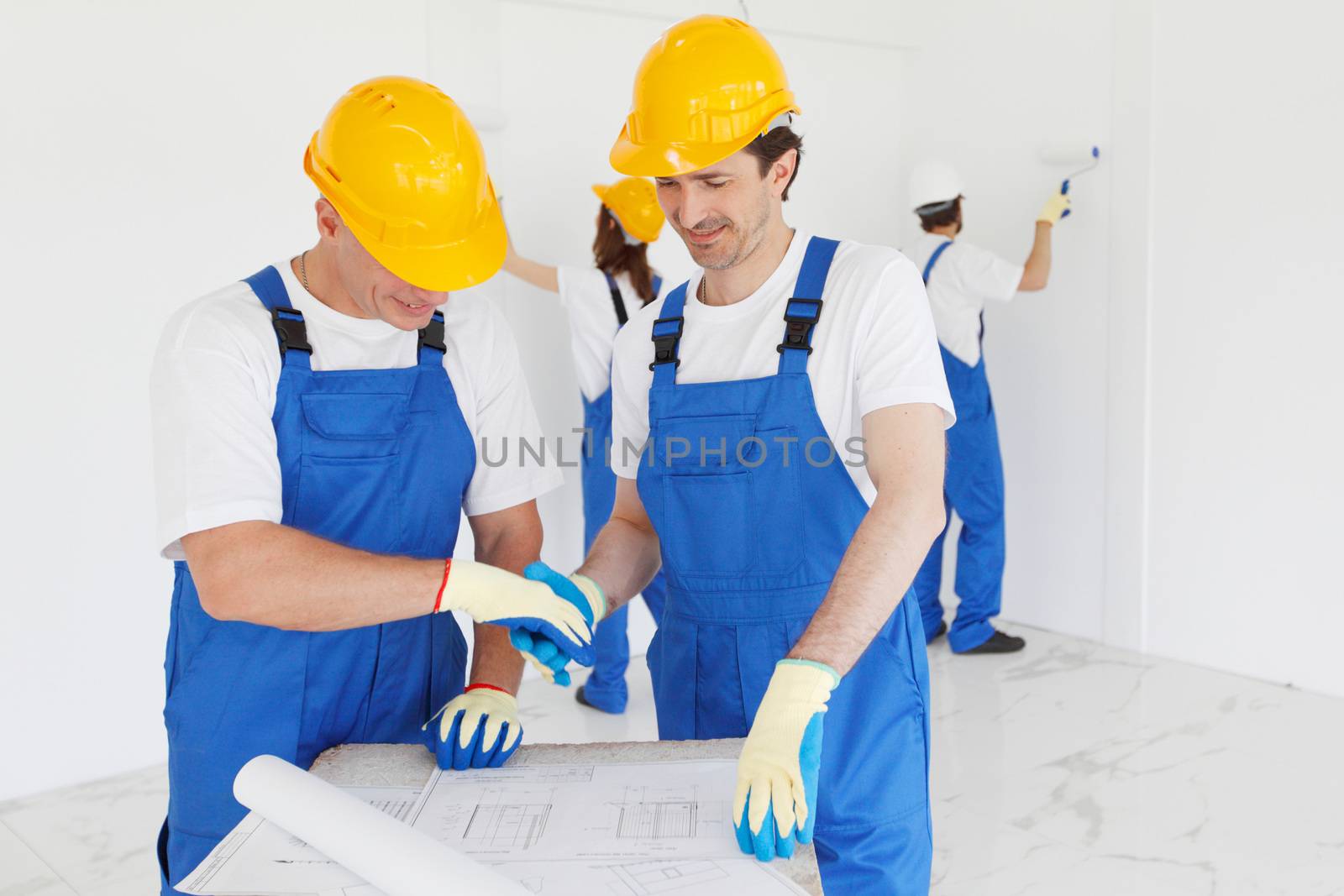 team of workmen looking at house design